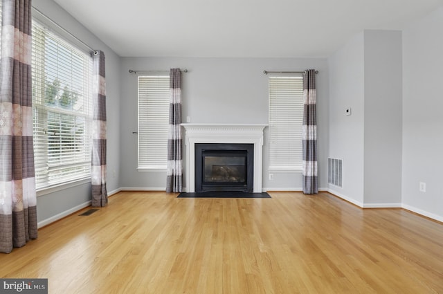 42827 Freedom St, Chantilly, VA 20152 - unfurnished living room with wood finished floors, baseboards, and a fireplace with flush hearth