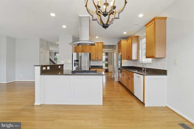 42827 Freedom St, Chantilly, VA 20152 - kitchen with appliances with stainless steel finishes, range hood, a sink, a chandelier, and backsplash