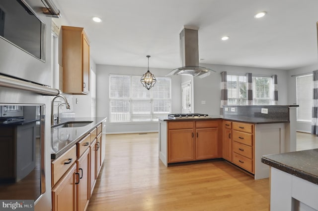 42827 Freedom St, Chantilly, VA 20152 - kitchen featuring island exhaust hood, a sink, light wood-style floors, stainless steel appliances, and hanging light fixtures