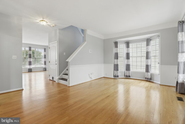 42827 Freedom St, Chantilly, VA 20152 - unfurnished living room with stairway, light wood-type flooring, baseboards, and crown molding