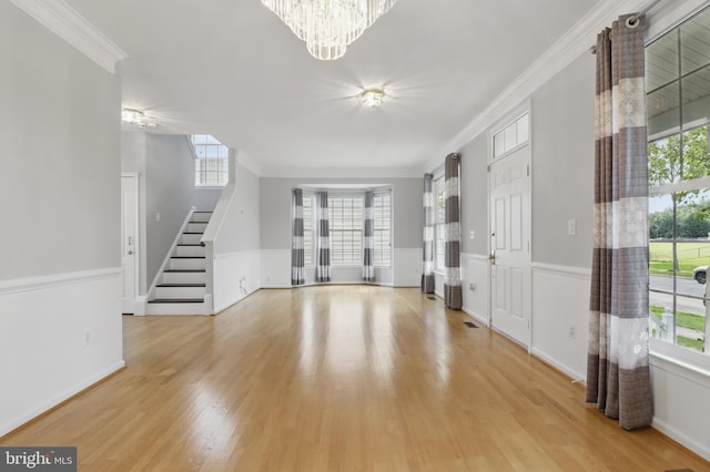42827 Freedom St, Chantilly, VA 20152 - foyer entrance with a chandelier, stairway, light wood-style flooring, healthy amount of natural light, and ornamental molding