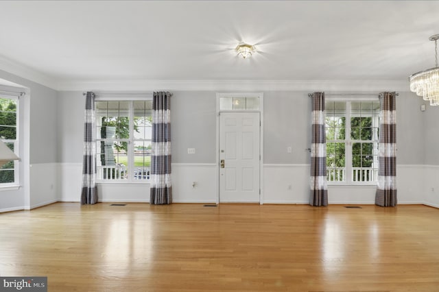 42827 Freedom St, Chantilly, VA 20152 - entrance foyer with a chandelier, light wood finished floors, crown molding, and baseboards