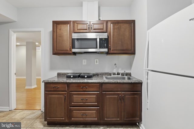 42827 Freedom St, Chantilly, VA 20152 - kitchen with freestanding refrigerator, stainless steel microwave, a sink, dark countertops, and baseboards