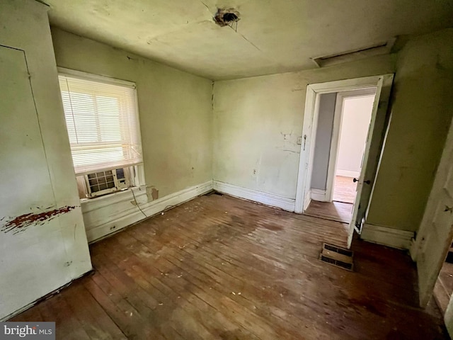407 Carruthers St, Lexington, VA 24450 - unfurnished bedroom with wood-type flooring, baseboards, cooling unit, and visible vents