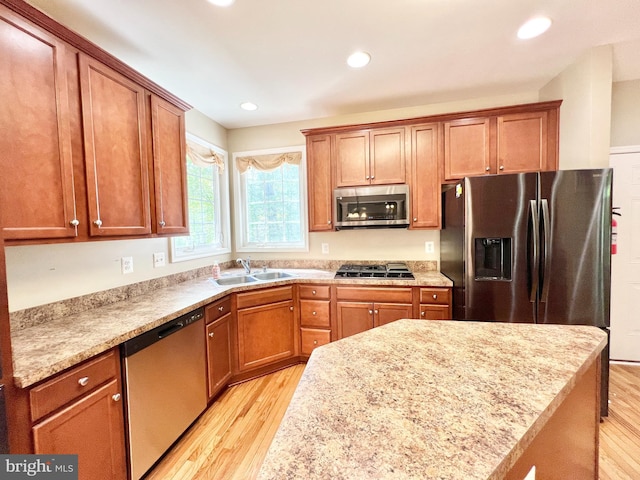 388 Wood Landing Rd, Fredericksburg, VA 22405 - kitchen featuring a sink, light wood-style floors, stainless steel appliances, and brown cabinetry