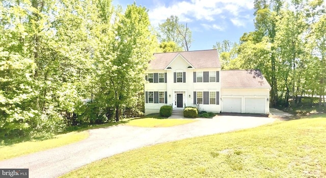388 Wood Landing Rd, Fredericksburg, VA 22405 - colonial home featuring roof with shingles, an attached garage, a front yard, and aphalt driveway