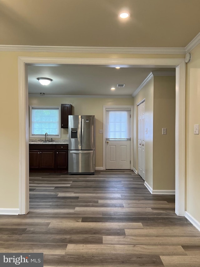 417 Bailey Ln, Salisbury, MD 21801 - kitchen featuring stainless steel refrigerator with ice dispenser, dark brown cabinetry, a sink, healthy amount of natural light, and crown molding