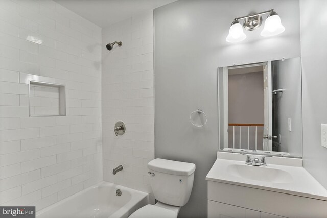 bathroom with shower / bathtub combination, toilet, and vanity