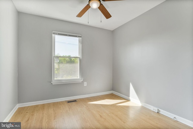 unfurnished room with a ceiling fan, baseboards, visible vents, and light wood-style flooring
