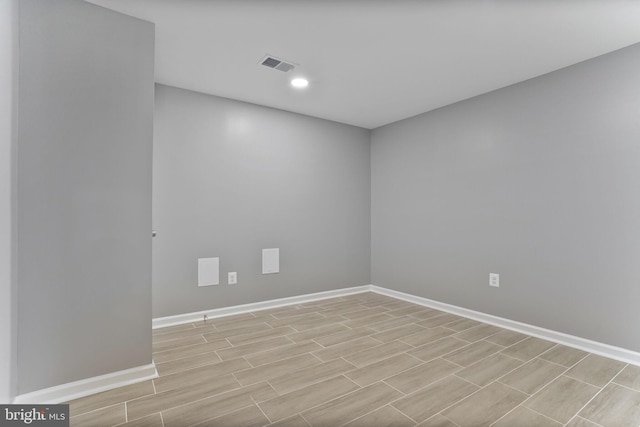 empty room featuring recessed lighting, baseboards, visible vents, and wood finished floors