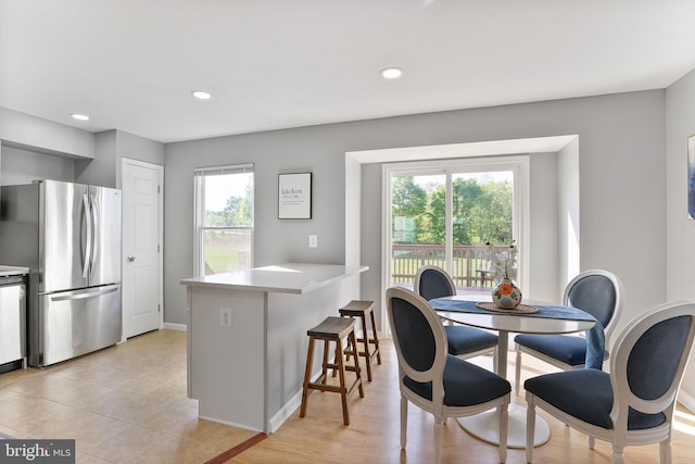 dining area with baseboards and recessed lighting
