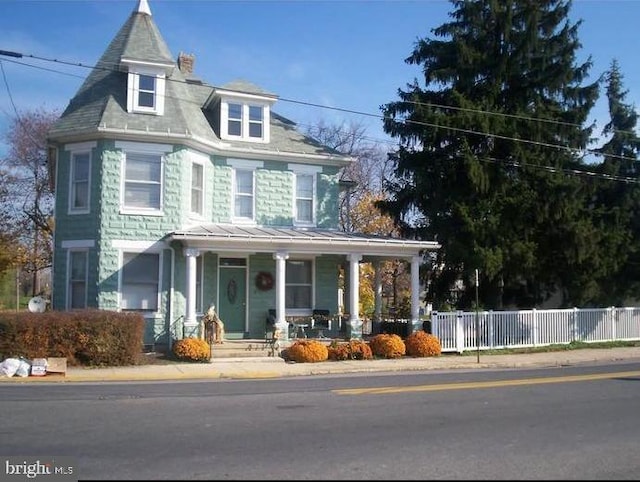 9 Queen St N, Shippensburg, PA 17257 - victorian-style house featuring covered porch, a standing seam roof, and fence