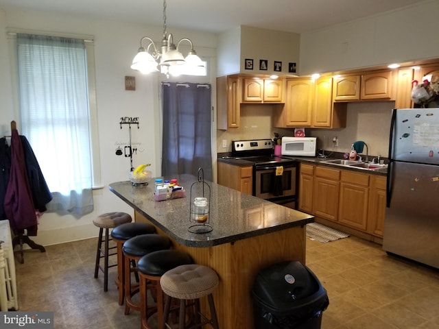 9 Queen St N, Shippensburg, PA 17257 - kitchen featuring a sink, appliances with stainless steel finishes, a kitchen bar, an island with sink, and a notable chandelier