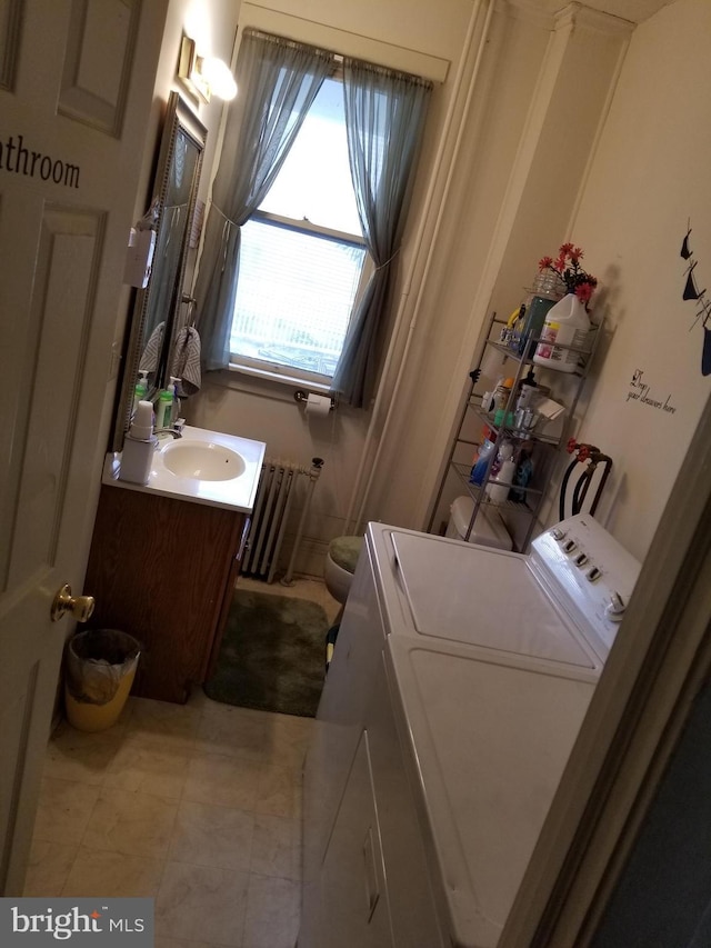 9 Queen St N, Shippensburg, PA 17257 - clothes washing area featuring tile patterned floors, a sink, radiator heating unit, and laundry area