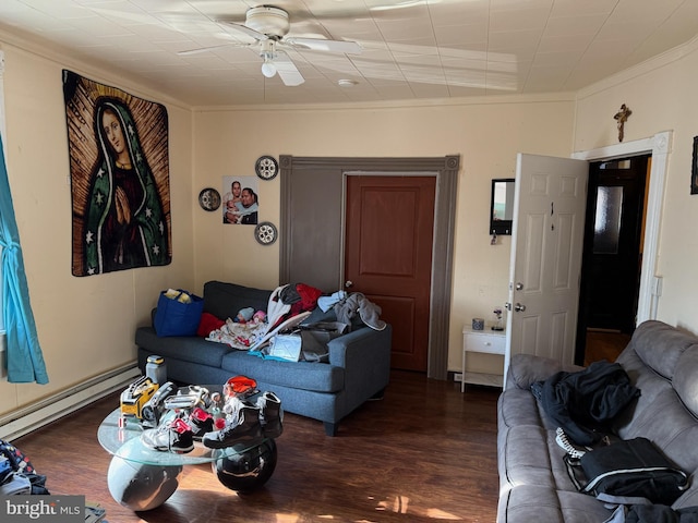 living area featuring baseboard heating, wood finished floors, ceiling fan, and crown molding