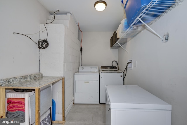 34 Pittman Ln, Sicklerville, NJ 08081 - clothes washing area with concrete block wall, laundry area, washing machine and dryer, and light tile patterned floors