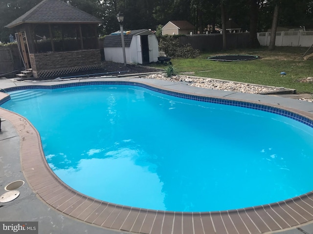 34 Pittman Ln, Sicklerville, NJ 08081 - view of pool with a gazebo, a fenced in pool, a fenced backyard, a storage unit, and a yard