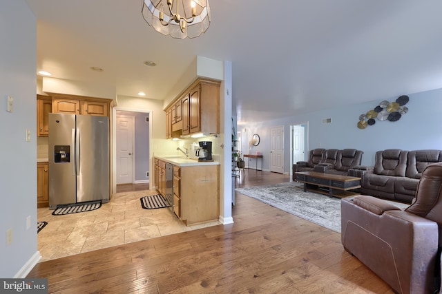 771 W Ridge Rd, Elizabethtown, PA 17022 - kitchen with a notable chandelier, a sink, light countertops, stainless steel appliances, and open floor plan
