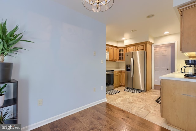 771 W Ridge Rd, Elizabethtown, PA 17022 - kitchen with glass insert cabinets, baseboards, light countertops, appliances with stainless steel finishes, and a notable chandelier