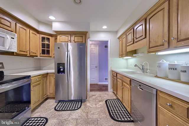 771 W Ridge Rd, Elizabethtown, PA 17022 - kitchen featuring a sink, light countertops, stainless steel appliances, stone finish flooring, and glass insert cabinets
