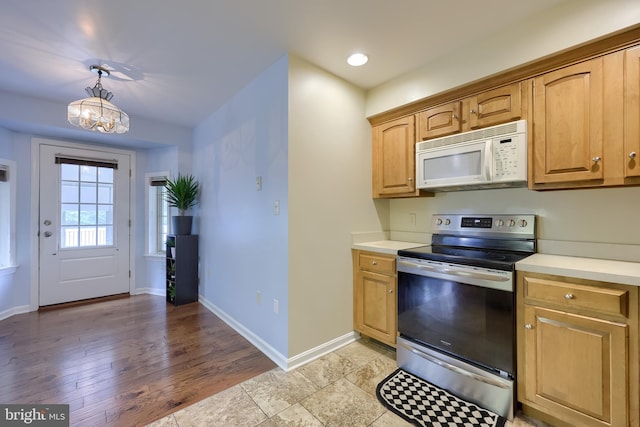 771 W Ridge Rd, Elizabethtown, PA 17022 - kitchen featuring light countertops, baseboards, stainless steel electric stove, and white microwave