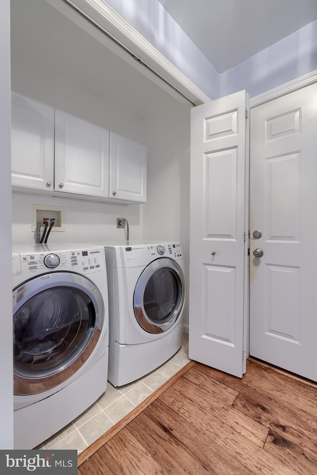 771 W Ridge Rd, Elizabethtown, PA 17022 - washroom with cabinet space, light wood finished floors, and washer and dryer
