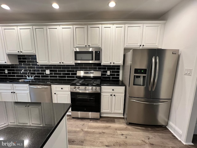 6232 N 10th St, Philadelphia, PA 19141 - kitchen featuring white cabinetry, stainless steel appliances, light wood finished floors, and a sink