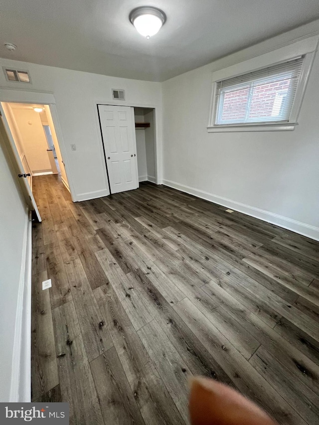 6232 N 10th St, Philadelphia, PA 19141 - unfurnished bedroom featuring dark wood-style floors, baseboards, visible vents, and a closet