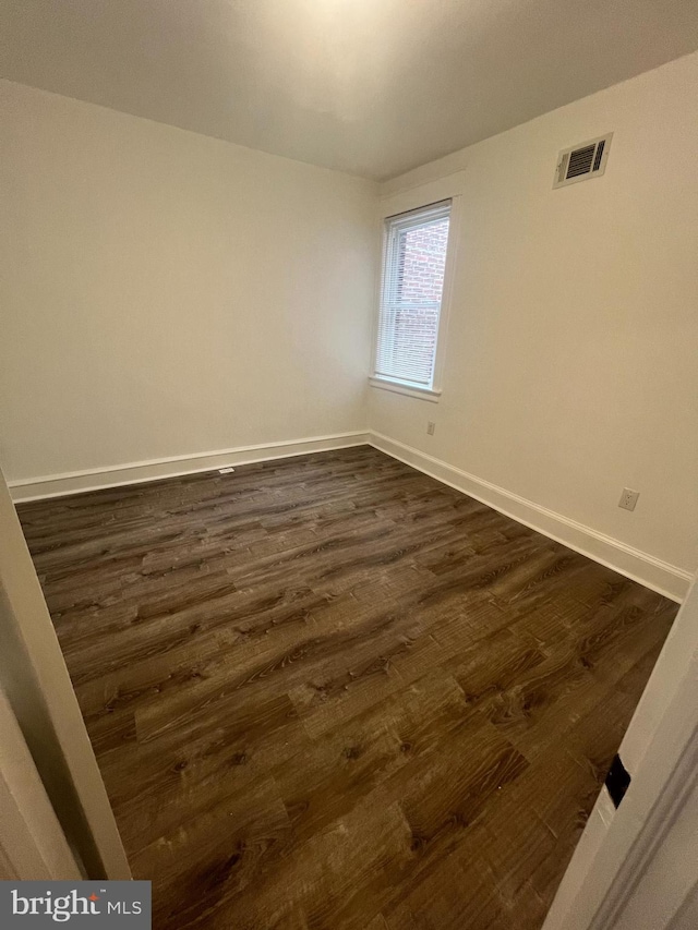 6232 N 10th St, Philadelphia, PA 19141 - empty room with baseboards, visible vents, and dark wood-style floors