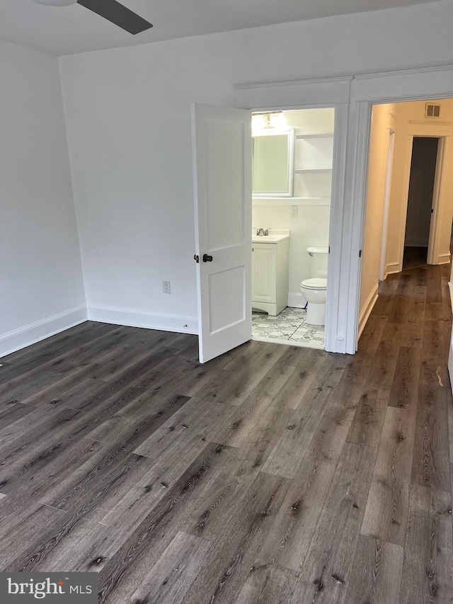 6232 N 10th St, Philadelphia, PA 19141 - unfurnished bedroom with visible vents, a sink, dark wood-type flooring, ensuite bath, and baseboards