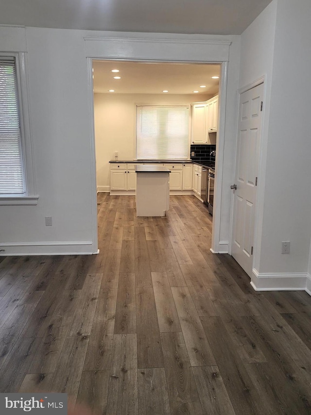 6232 N 10th St, Philadelphia, PA 19141 - kitchen featuring white cabinets, dark wood finished floors, dark countertops, a kitchen island, and baseboards