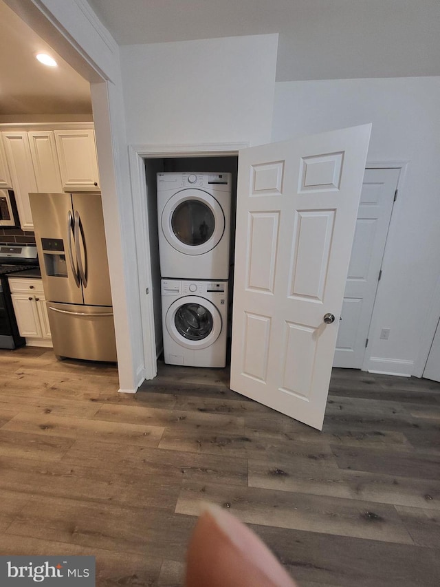 6232 N 10th St, Philadelphia, PA 19141 - clothes washing area featuring dark wood finished floors, stacked washer and clothes dryer, laundry area, and recessed lighting