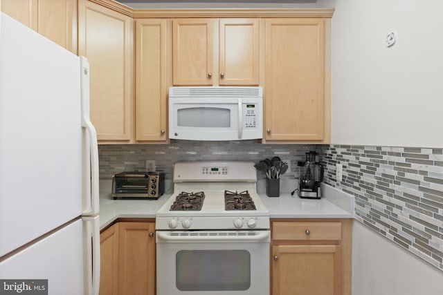 kitchen with white appliances, light countertops, light brown cabinetry, and tasteful backsplash