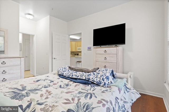 bedroom with baseboards and wood finished floors