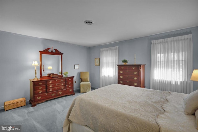carpeted bedroom featuring visible vents