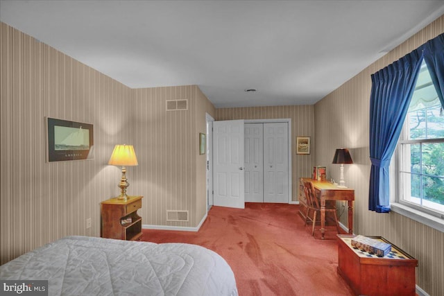 carpeted bedroom with baseboards, a closet, wallpapered walls, and visible vents