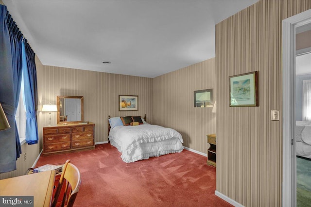 carpeted bedroom featuring wallpapered walls, multiple windows, and baseboards