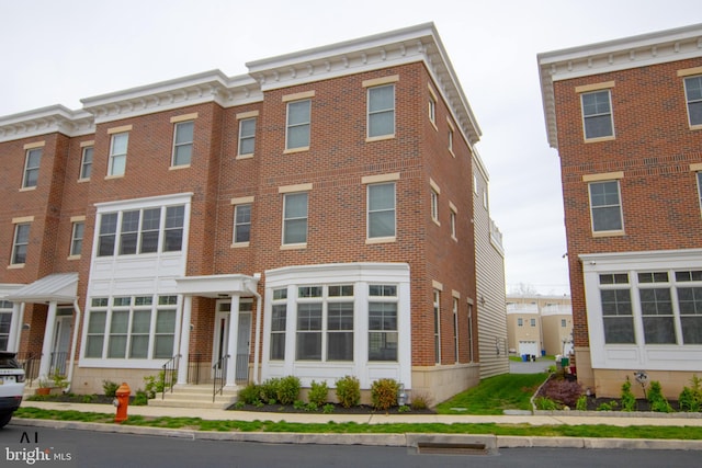 townhome / multi-family property featuring brick siding