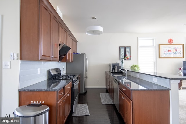 kitchen featuring range with gas cooktop, tasteful backsplash, stainless steel dishwasher, a sink, and baseboards