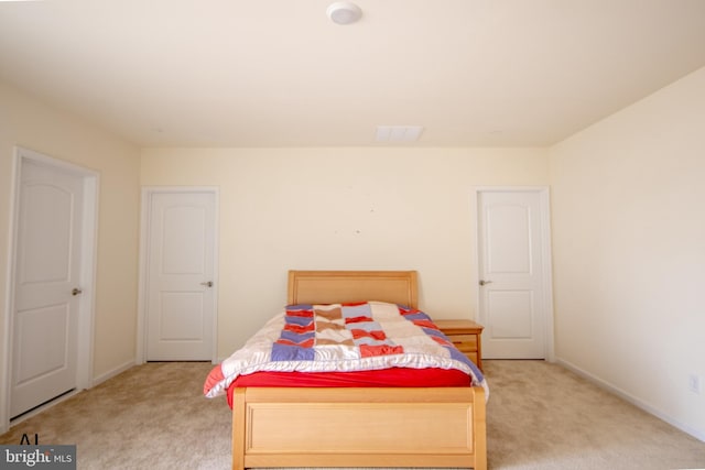 bedroom featuring baseboards and light colored carpet