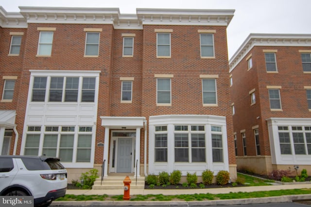 view of front of house featuring brick siding