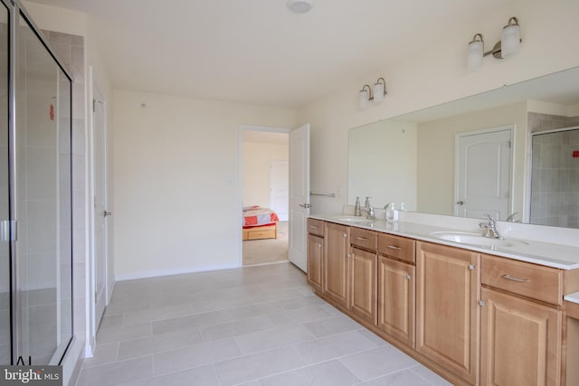 ensuite bathroom with a sink, ensuite bathroom, a shower stall, and double vanity