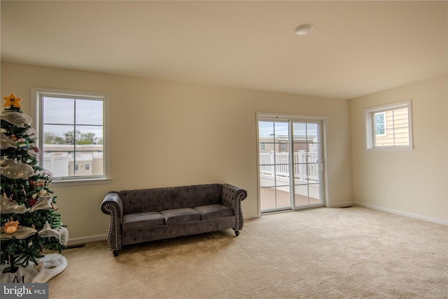 living area featuring carpet floors and baseboards
