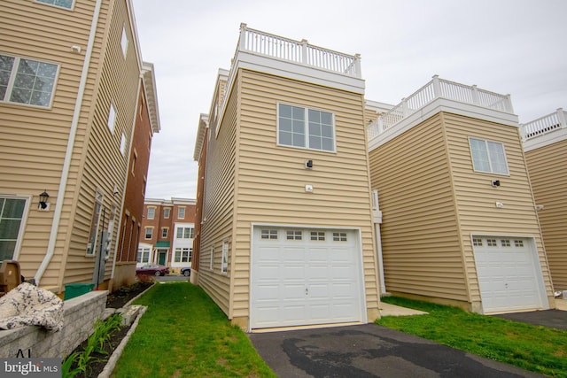 view of front of property featuring a garage and aphalt driveway