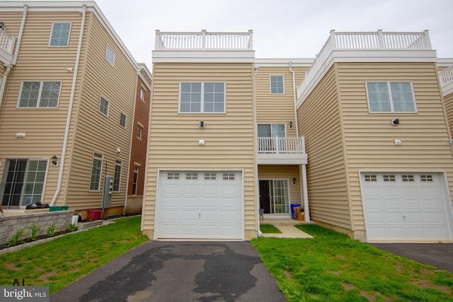 townhome / multi-family property featuring a garage and aphalt driveway
