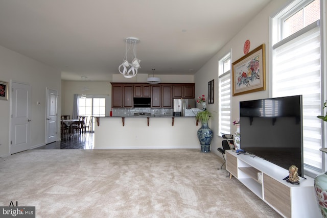 living area with carpet floors and an inviting chandelier