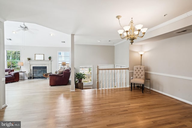 living area with visible vents, wood finished floors, and a healthy amount of sunlight