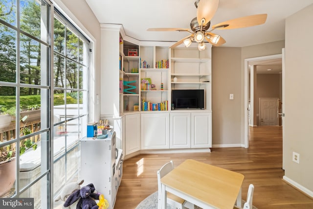 interior space with ceiling fan, light wood-style flooring, and baseboards