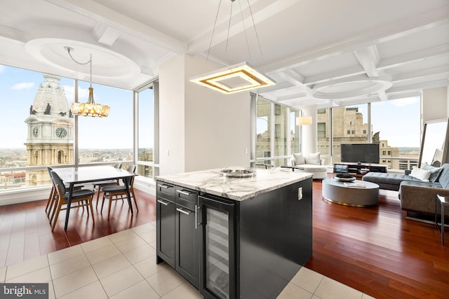 1414 S Penn Sq Unit 34B, Philadelphia, PA 19102 - kitchen with coffered ceiling, dark cabinetry, plenty of natural light, and beverage cooler
