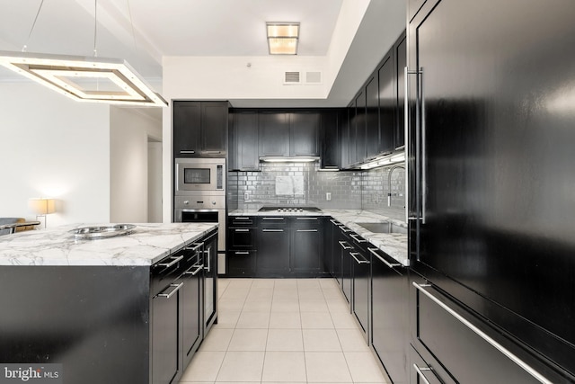 1414 S Penn Sq Unit 34B, Philadelphia, PA 19102 - kitchen featuring light tile patterned flooring, a sink, dark cabinetry, and stainless steel appliances